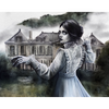 Woman in a historical dress standing in front of an old house with a misty background